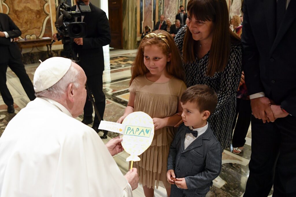 The Pope accepts artwork from children during an audience with members of the Federation of Catholic Family Associations in Europe at the Vatican.
