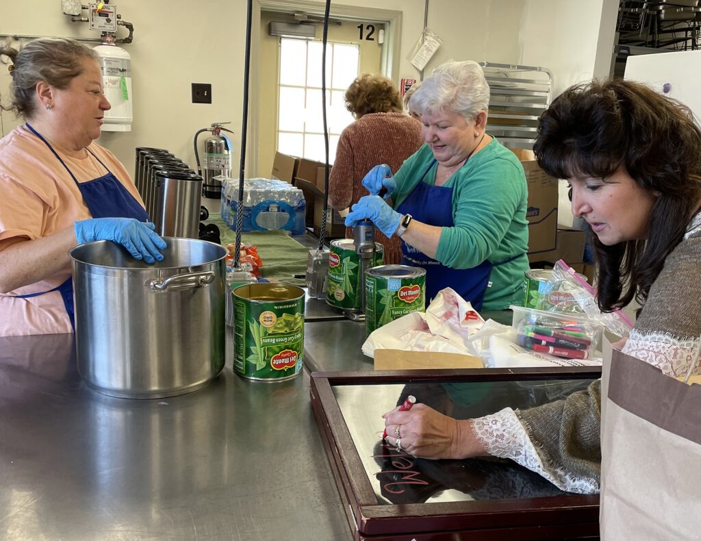 Volunteer cooks from the Holy CHOW (Christian Hospitality on Wheels) food truck, a ministry of St. Joseph Parish in Hillsborough, N.J., prepare food in the church kitchen in December 2022.
