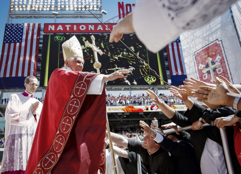 Pope Benedict XVI reaches out to people after celebrating Mass at Nationals Park in Washington April, 17, 2008.