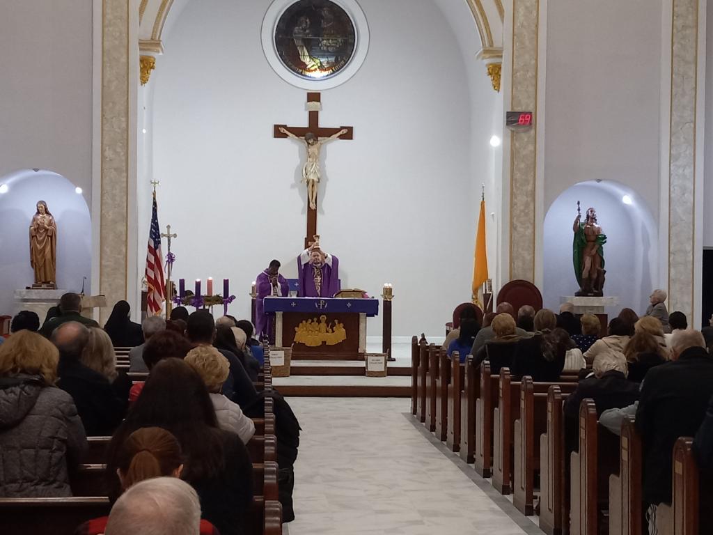 Photo shows Bishop Edmund Whalen celebrating Mass at St. Rock Church on Staten Island.