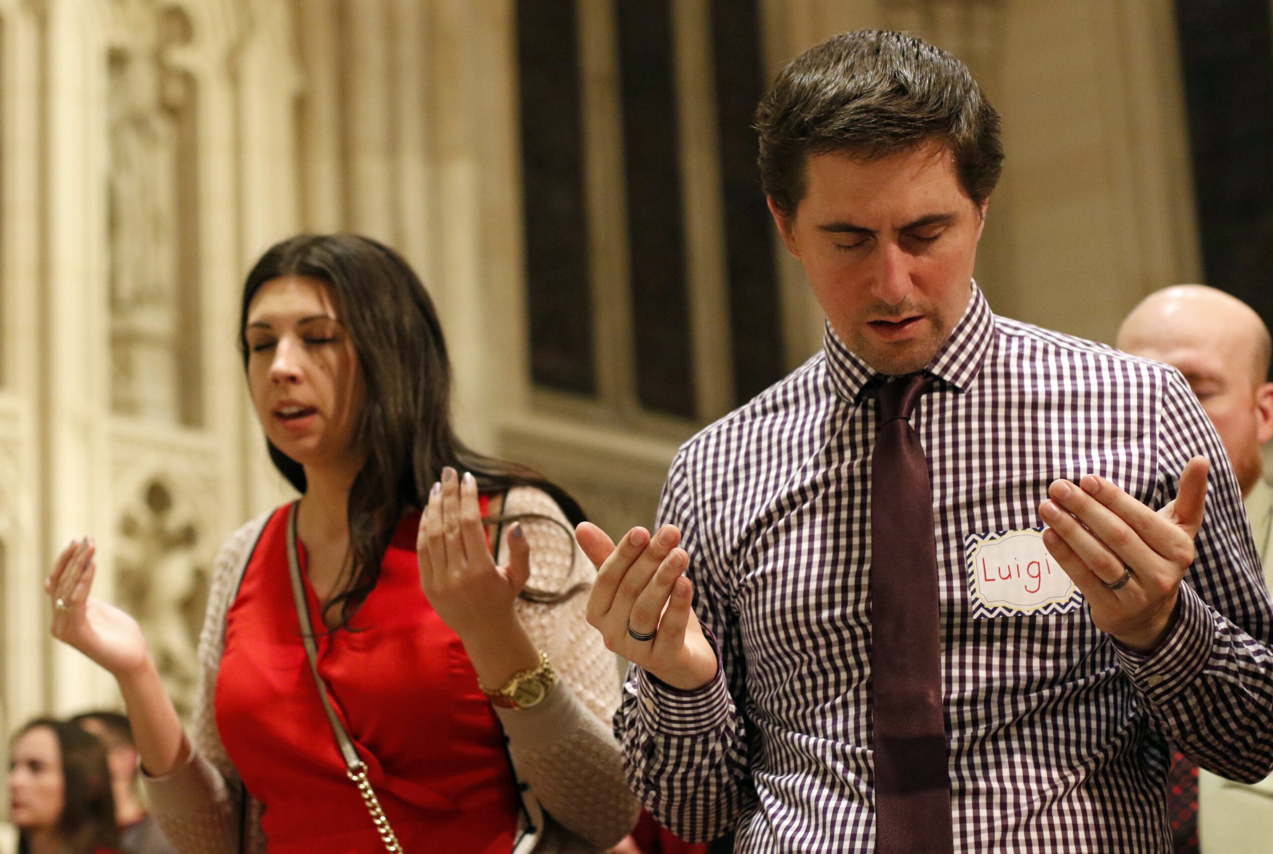 People pray during a Mass for young adults Dec. 9, 2015, at St. Patrick's Cathedral in New York City.