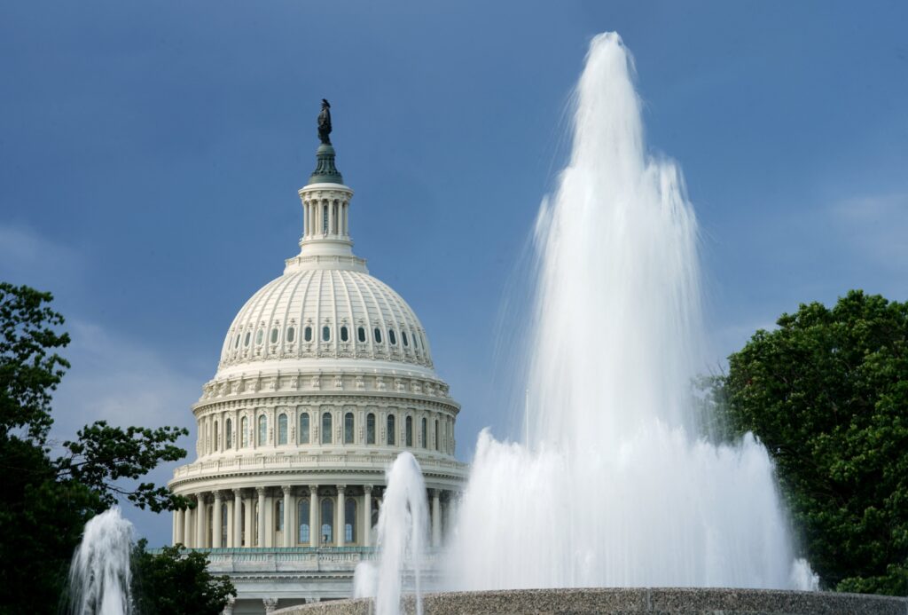 The dome of the U.S. Capitol in Washington is seen beyond a fountain .