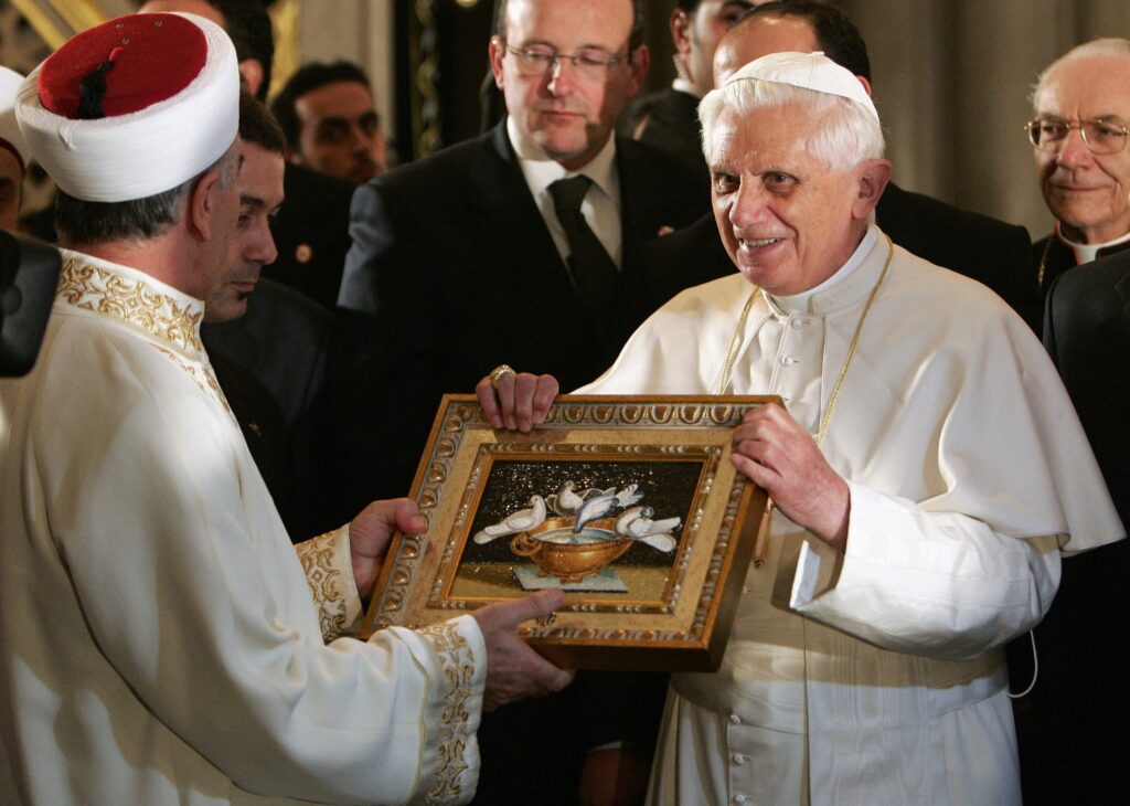 Pope Benedict XVI offers a gift to Mustafa Cagrici, the grand mufti of Istanbul, during his visit to the Blue Mosque in Istanbul, Turkey.