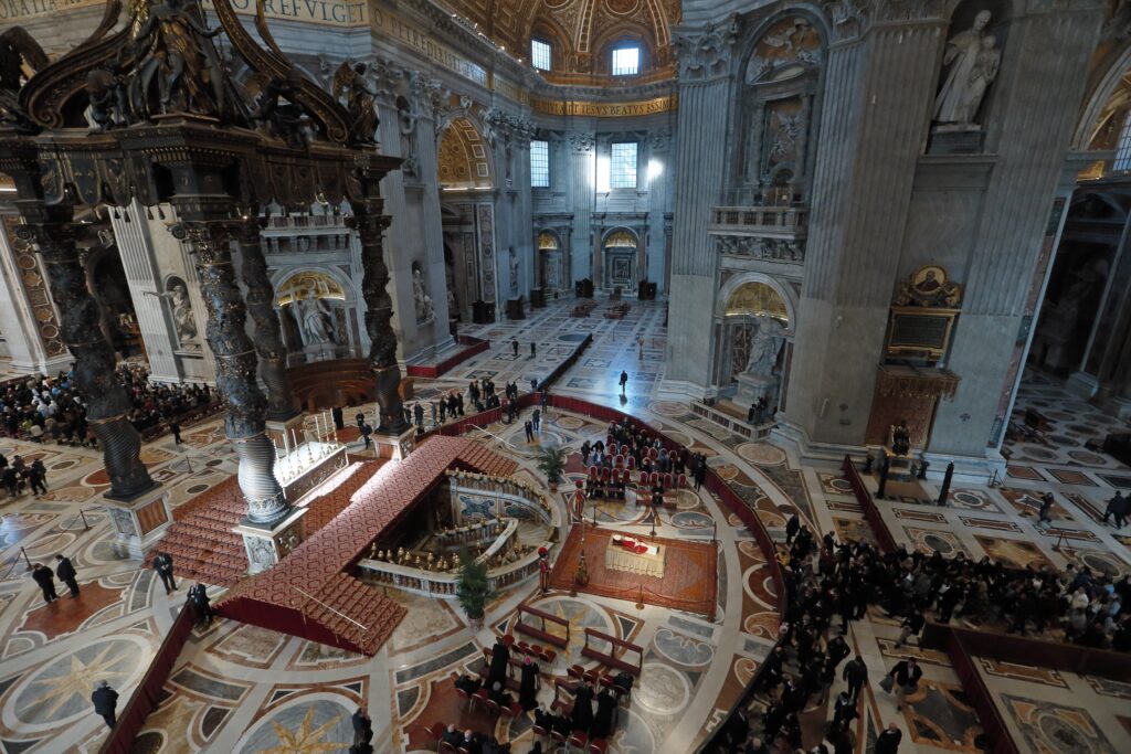 People pay their respects at the body of Pope Benedict XVI in St. Peter's Basilica at the Vatican Jan. 4, 2023.