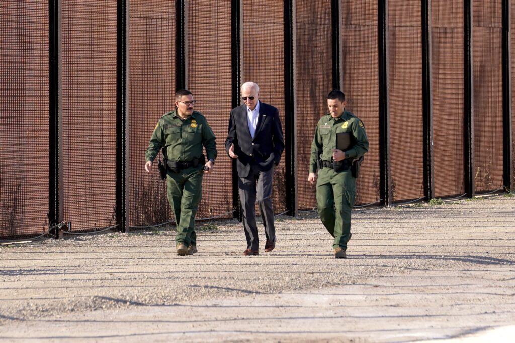 U.S. President Joe Biden walks with Border Patrol officers as he walks along the border fence during his visit to the U.S.-Mexico border to assess border enforcement operations in El Paso, Texas, Jan. 8, 2023.
