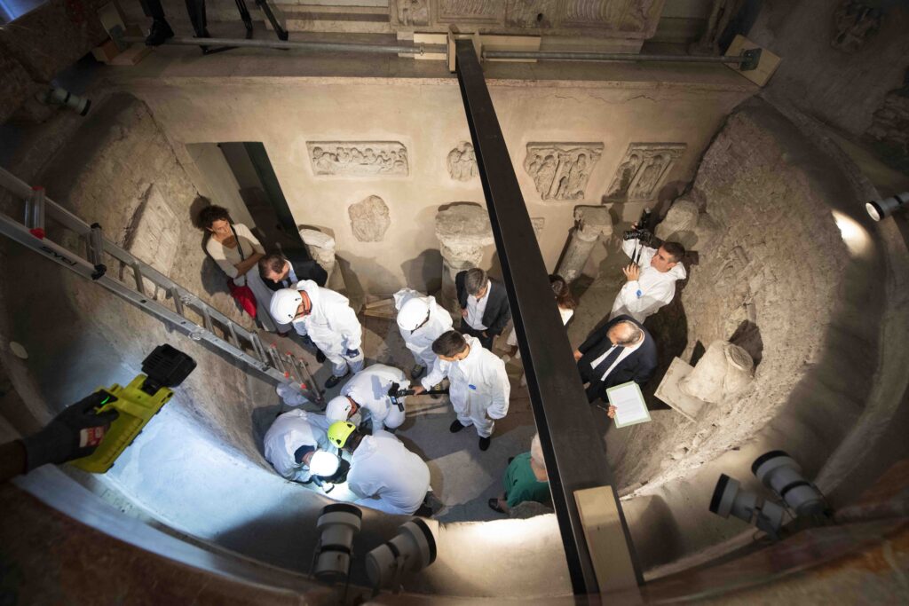 Workers inspect an ossuary at the Teutonic Cemetery at the Vatican in this July 20, 2019, file photo.