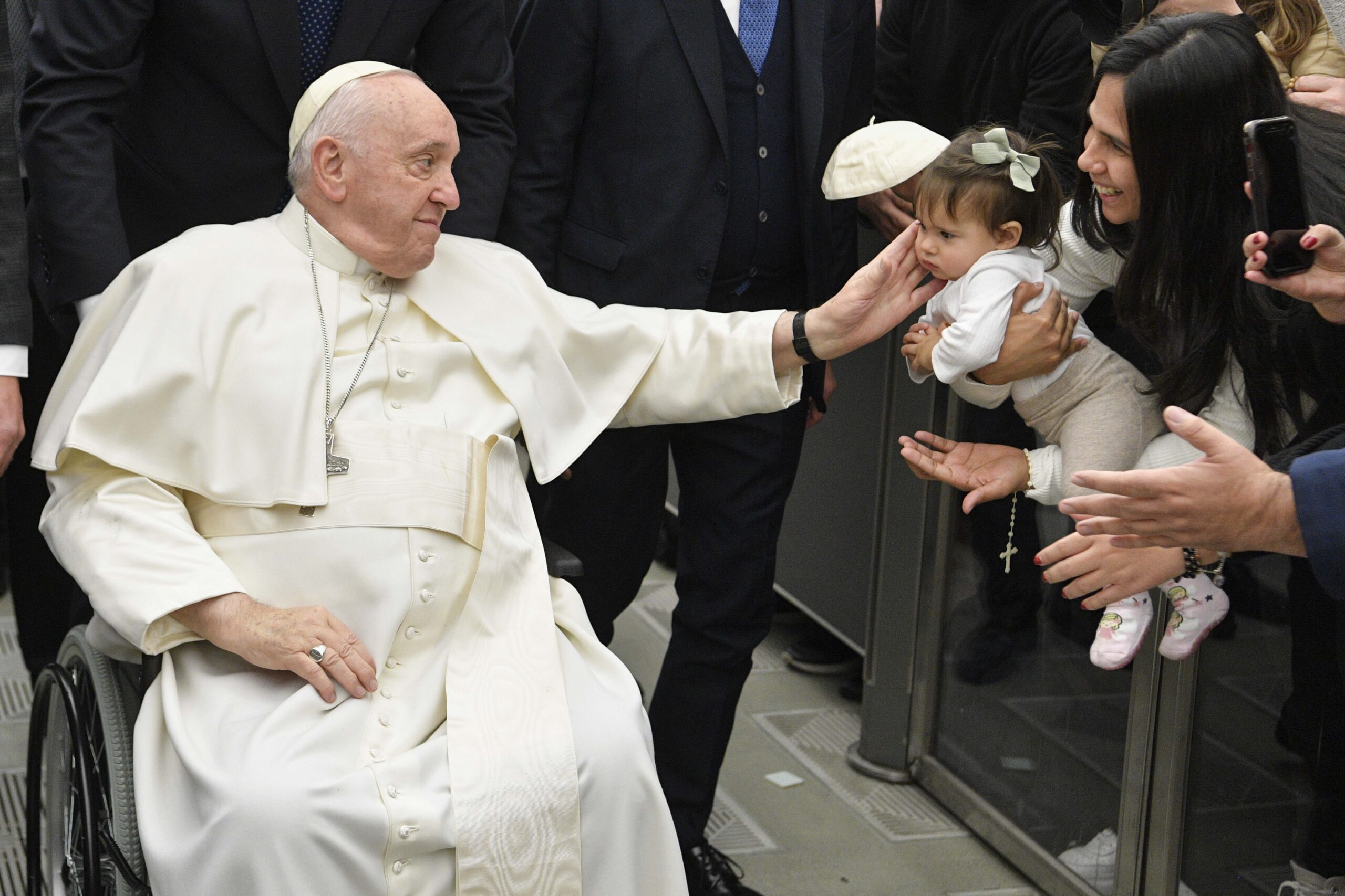 Pope Francis greets a baby during his general audience at the Vatican Jan. 25, 2023.