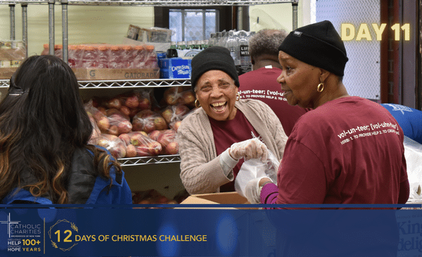 Volunteers serve food at a soup kitchen.