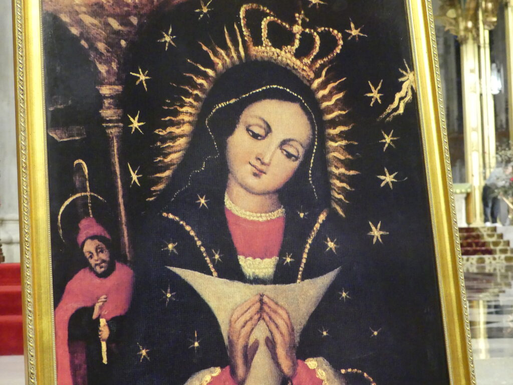 A replica of the original painting of Our Lady of Altagracia is a portrait of the Virgin Mary in a Nativity scene painted circa 1500 and kept in the Basilica Catedral Nuestra Señora de la Altagracia in the city of Higüey, Dominican Republic.