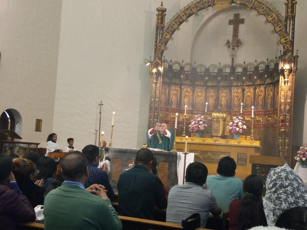 Auxiliary Bishop Joseph Espaillat during the Eucharistic consecration, at a Mass concluding a Charismatic retreat in the Bronx.