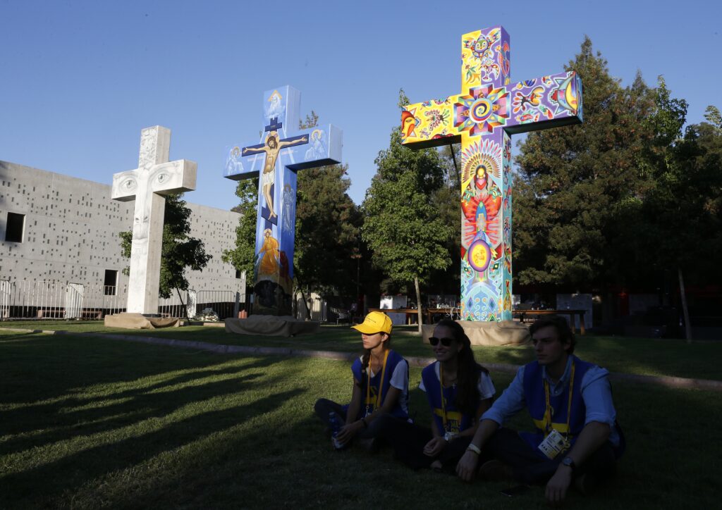 People wait near crosses before Pope Francis' encounter outside the shrine of St. Alberto Hurtado in Santiago, Chile, Jan. 16.