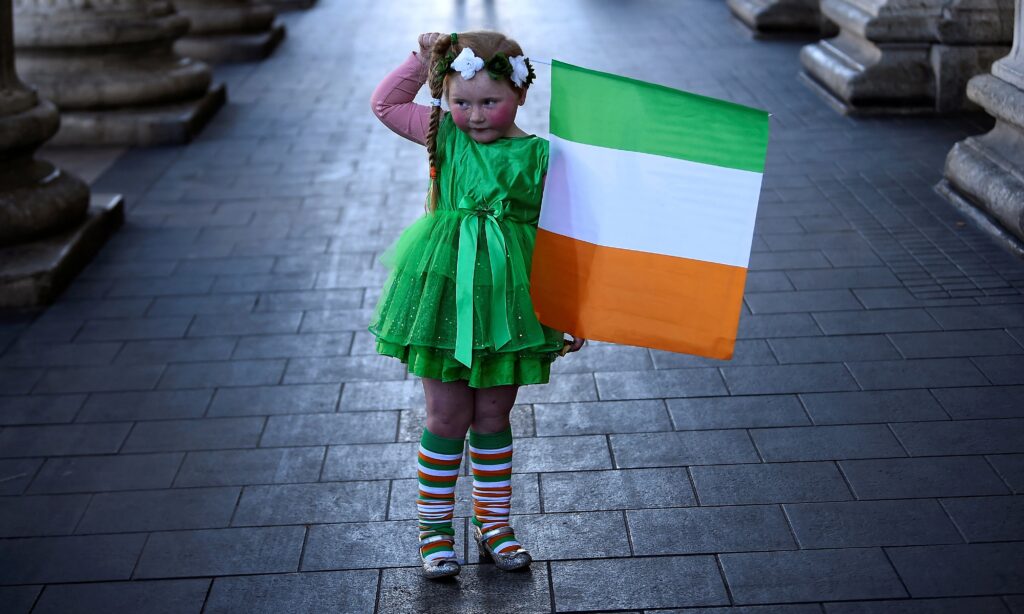 A girl who was part of a procession holds the flag of Ireland on St. Patrick's Day in Dublin March 17, 2021, during the COVID-19 pandemic.