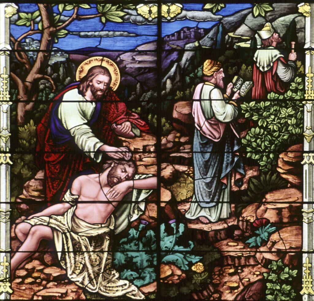 A stained-glass window at Sacred Heart Church in Freeport, Minn., depicts the good Samaritan.