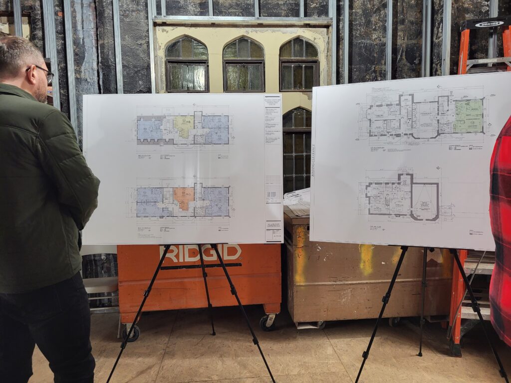 Floor plans of new, independent housing at ArchCare's St. Frances Cabrini Apartments at Immaculate Conception Church are displayed at a groundbreaking ceremony, March 1, 2023.