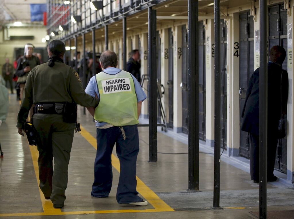 A guard escorts an inmate down a corridor during a 2016 media tour of death row at San Quentin State Prison in California.