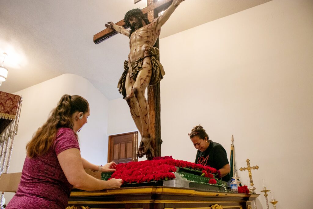 Parishioners at Corpus Christi Parish in Miami decorate the platform of the Christ of Mercy (Cristo de la Misericordia) for the Good Friday procession April 15, 2022. The cedar wood sculpture made by Juan Manuel Miñarro, who studied the Shroud of Turin and the Sudarium of Oviedo, depicts Jesus Christ crucified. (OSV News