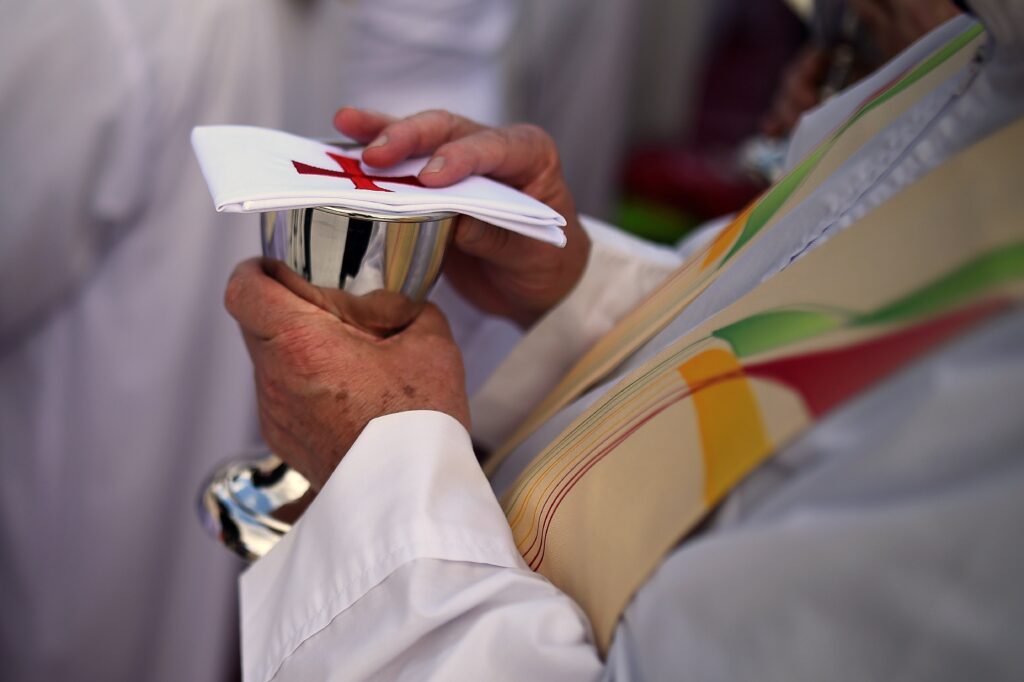 A priest in Dublin, Ireland, holds a chalice during Mass at the World Meeting of Families Aug. 22, 2018.