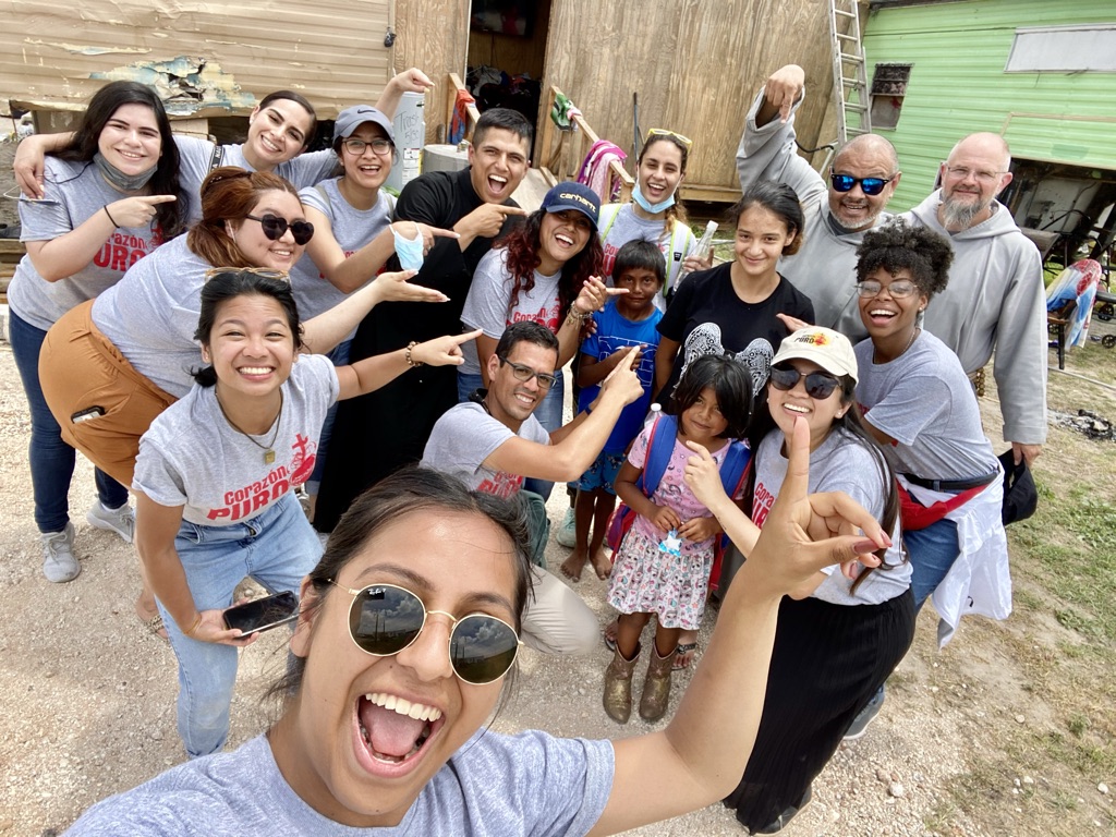 Father Torres with Corazon Puro staff and volunteers at the U.S./Mexico border in Texas in 2021. The young woman was receiving special attention because it was her birthday.