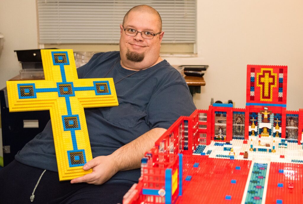 At his home in Saginaw, Mich., 45-year-old John Kraemer spends hours each day at his craft and vocation -- building elaborate models of Catholic churches, then filling them with figures for display at various parishes.