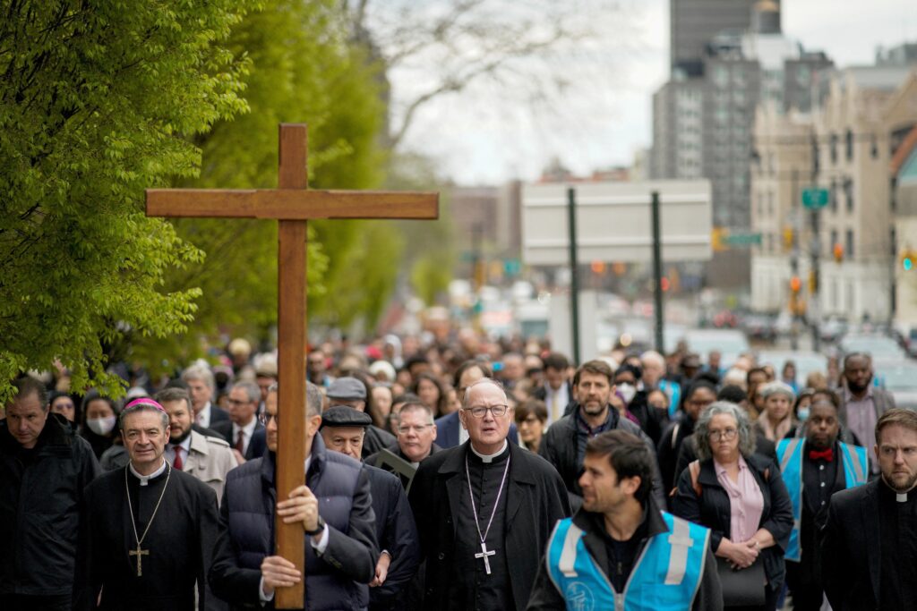 New York Cardinal Timothy M. Dolan, center, with Brooklyn Bishop Robert J. Brennan, left, lead the Way of the Cross over the Brooklyn Bridge in New York April 7, 2023.