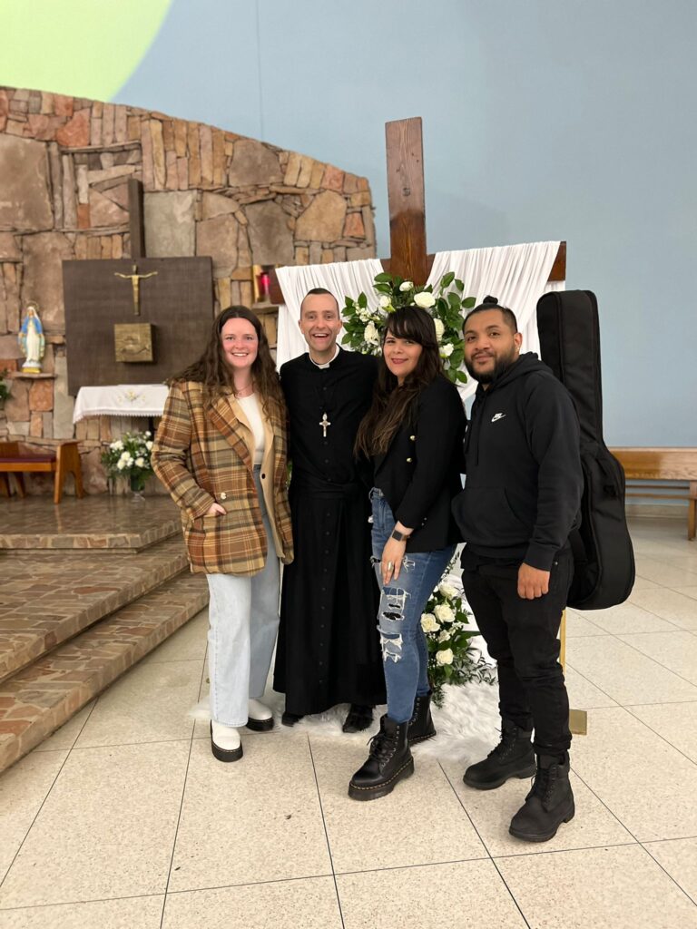 Father Vincent Druding of Holy Cross parish in The Bronx poses with parishioners on the final day of their Lenten Revival, April 9, 2023.