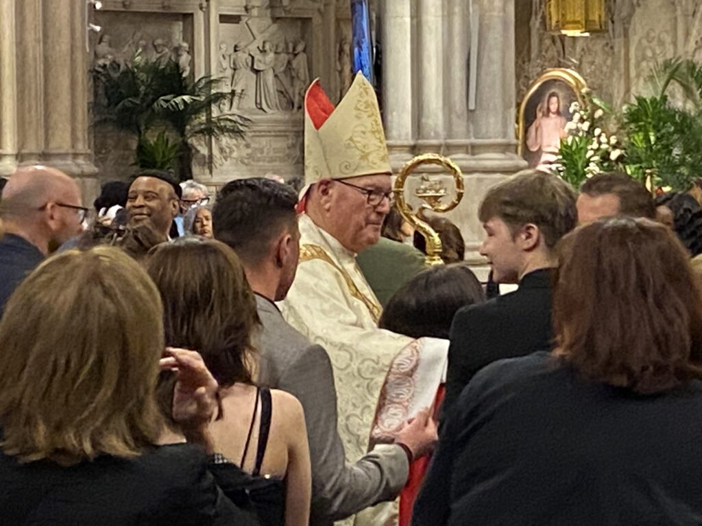 Cardinal Timothy Dolan talks with a sponsor of a newly confirmed young person with disabilities at the Celebration of Confirmation for Youth with Disabilities, held Sunday, April 16, 2023, at St. Patrick's Cathedral.