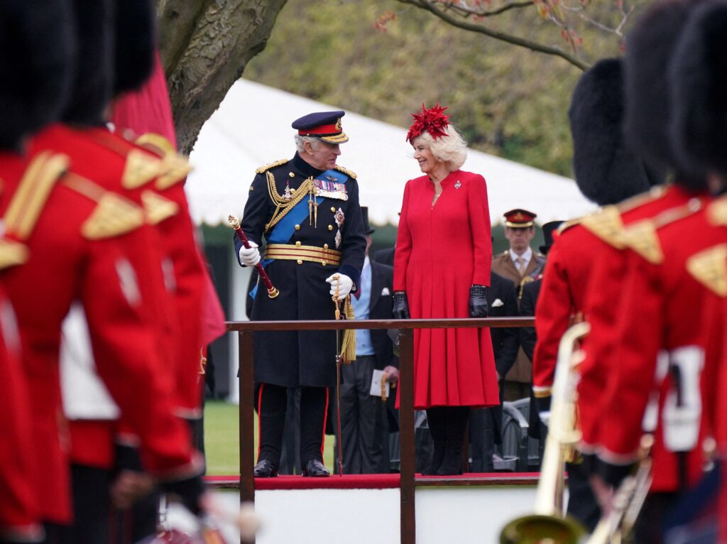 King Charles III and Camilla, Queen Consort, attend a ceremony at Buckingham Palace in London on April 27, 2023.