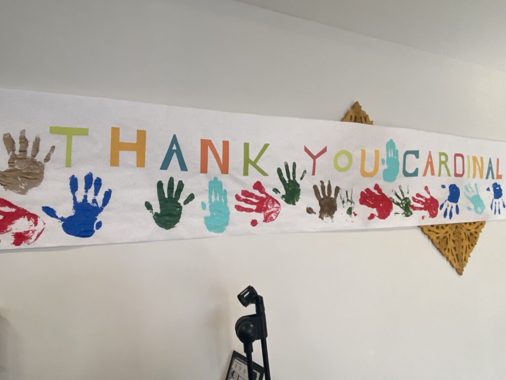 A banner made by the residents of ArchCare at St. Teresa is displayed ahead of Cardinal Timothy Dolan's visit, May 10, 2023.