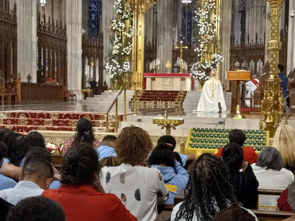 Father Shane Johnson kneels before the Blessed Sacrament during a Pentecost eve vigil at St. Patrick's Cathedral, May 27, 2023.