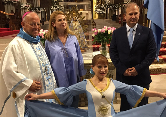 Bishop Emeritus Eduardo Maria Taussig of Argentina is joined by some of the faithful for a photo after the 2023 Our Lady of Lujan Mass at St. Patrick's Cathedral.