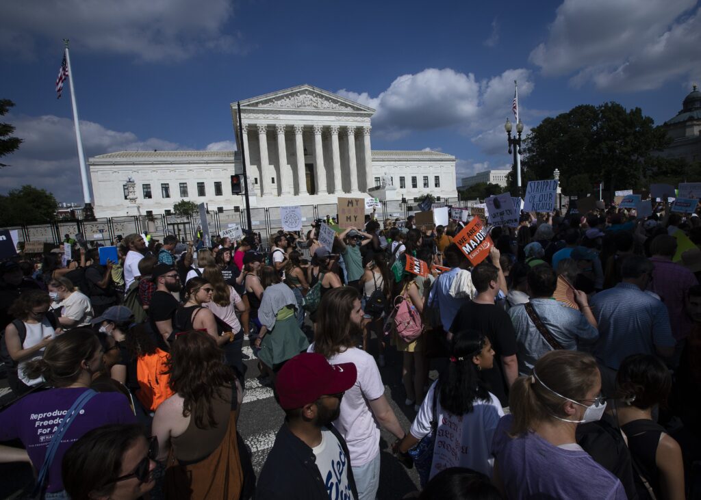 Abortion demonstrators are seen near the Supreme Court in Washington on June 24, 2022, as the court overruled the landmark Roe v. Wade abortion decision in its ruling in the Dobbs case on a Mississippi law banning most abortions after 15 weeks.
