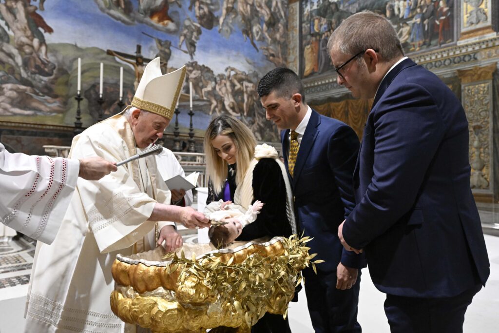 Pope Francis baptizes a baby during a Mass in the Sistine Chapel at the Vatican in this file photo from Jan. 8, 2023.