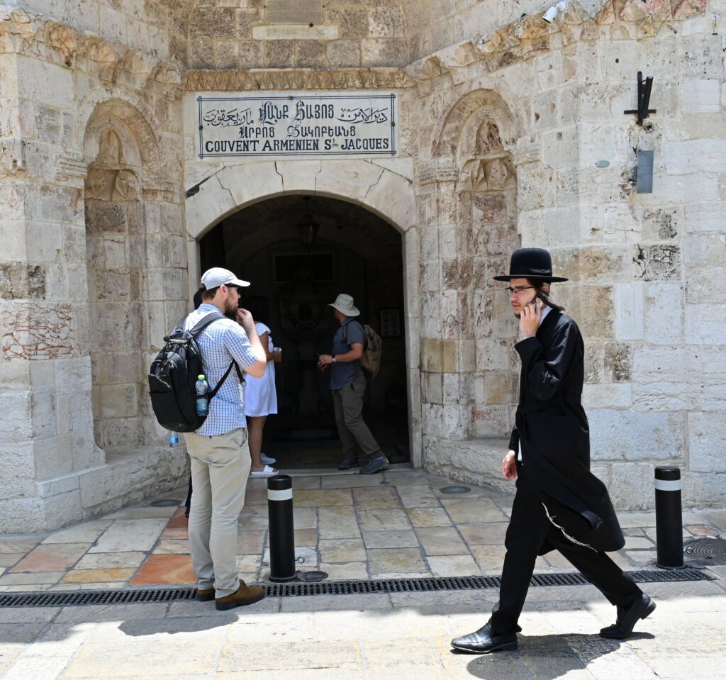 An Ultra-Orthodox Jewish man walks past the entrance to the Armenian St. James Cathedral in the Old City of Jerusalem June 18, 2023.