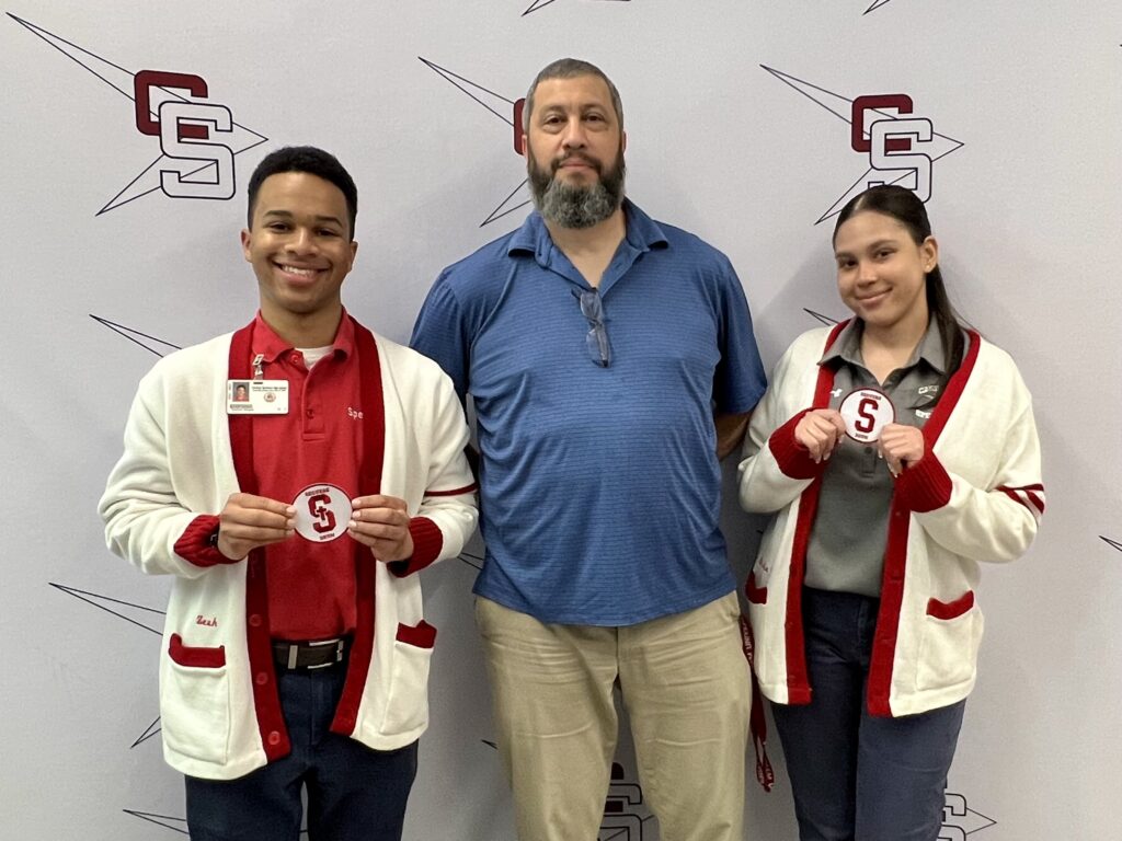 Michael Borges, chairperson of the Theology Department at Cardinal Spellman High School in the Bronx, with Ezekiel Vargas and Erika Grullon, both of whom graduated from Spellman on June 3.