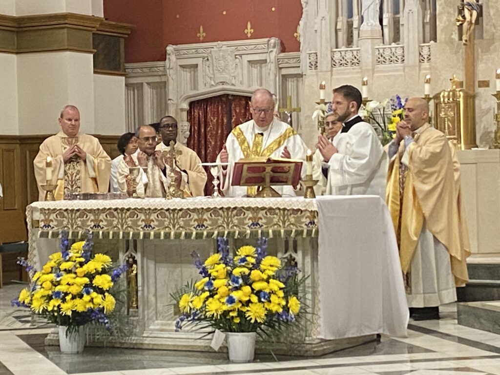 Cardinal Timothy Dolan (center right) celebrates Mass for the 125th anniversary of St. Philip Neri in the Bronx, joined by Auxiliary Bishop Joseph Espaillat (right) and Father Daniel O'Reilly (left) current pastor of St. Philip Neri.