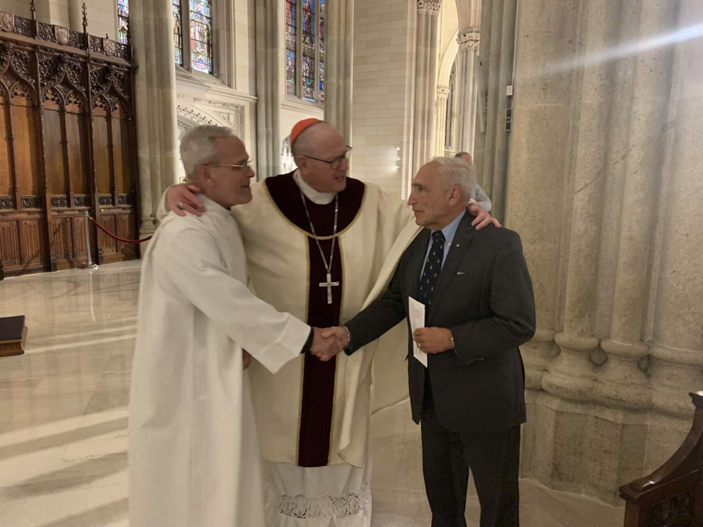 Joseph Sciame, president of the American Foundation of Savoy Orders, right, presented a check for $4,000 to CNEWA’s chair, Timothy Cardinal Dolan of New York, center, and CNEWA’s president, Msgr. Peter I. Vaccari, left, at St. Patrick’s Cathedral in Manhattan on June 27, 2023.