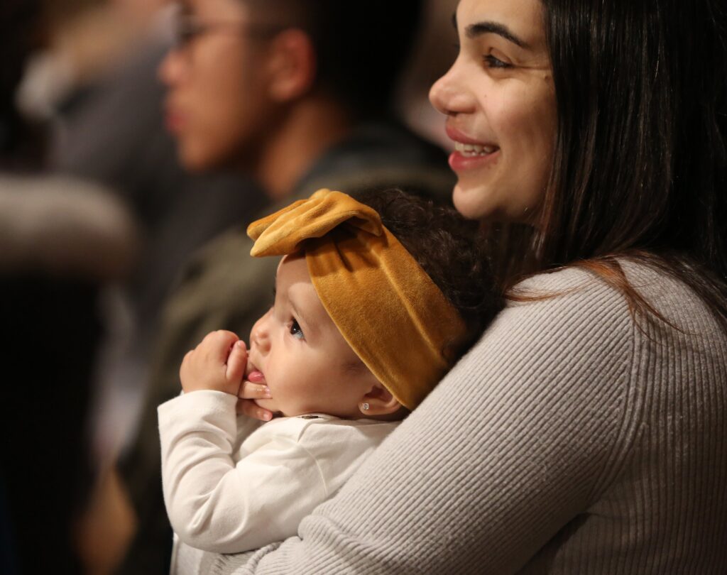 A woman holds her daughter during the opening Mass Jan. 19, 2023, at the Basilica of the National Shrine of the Immaculate Conception in Washington.