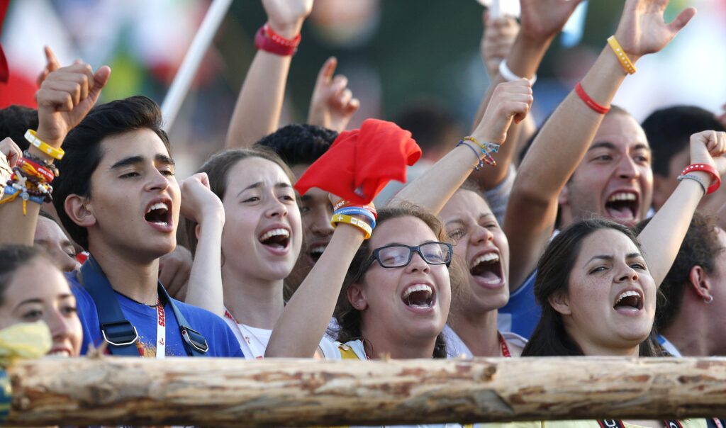 Pilgrims cheer after the Way of the Cross during World Youth Day in 2016 at Blonia Park in Krakow, Poland.