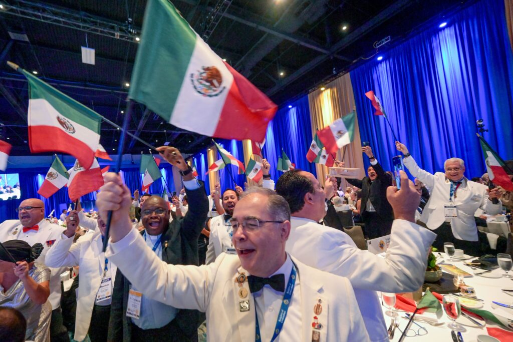 Knights of Columbus from Mexico wave their national flags at the States Dinner Aug. 1, 2023, during the fraternal order's 141st Supreme Convention in Orlando, Fla.