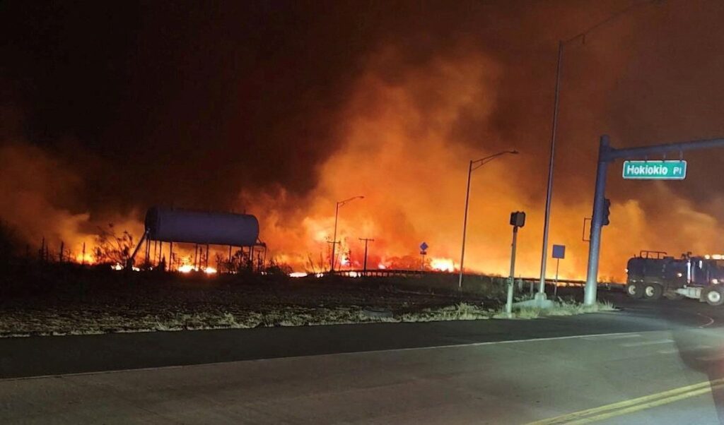 A wildfire burns on the island of Maui near an intersection in Lahaina, Hawaii, Aug. 9, 2023.