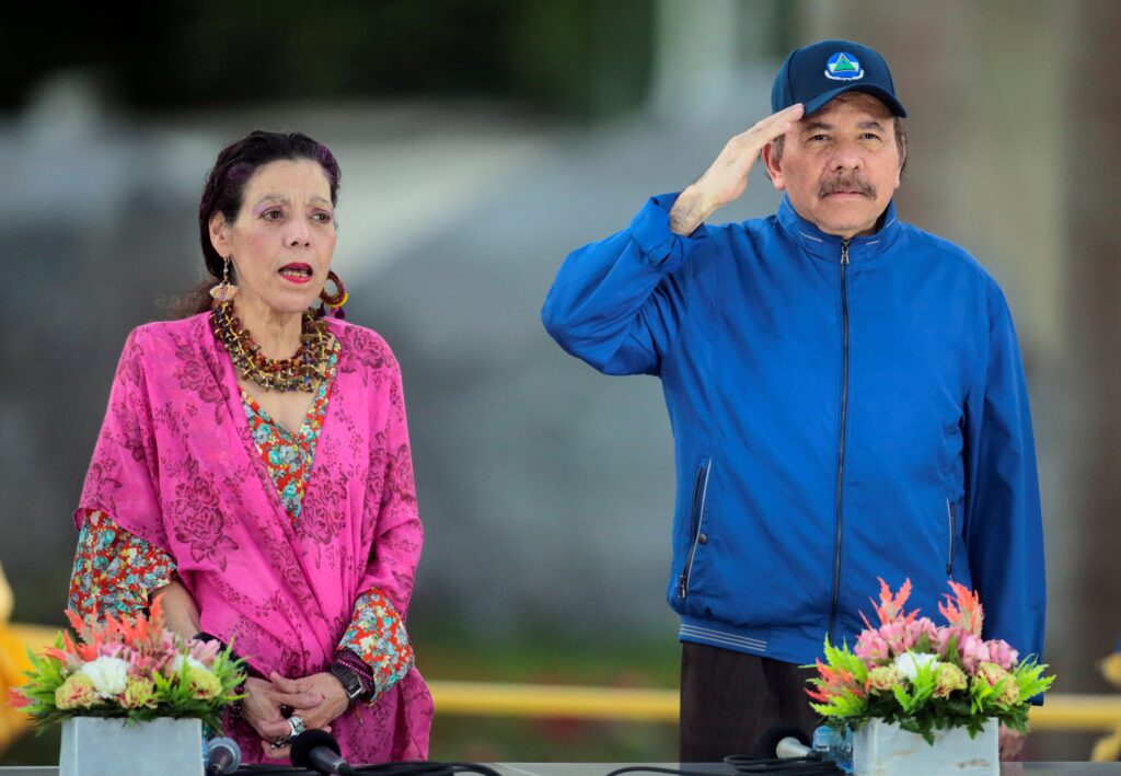 Nicaraguan President Daniel Ortega and Vice President Rosario Murillo sing the national anthem during the opening ceremony of a highway overpass in Managua March 21, 2019.