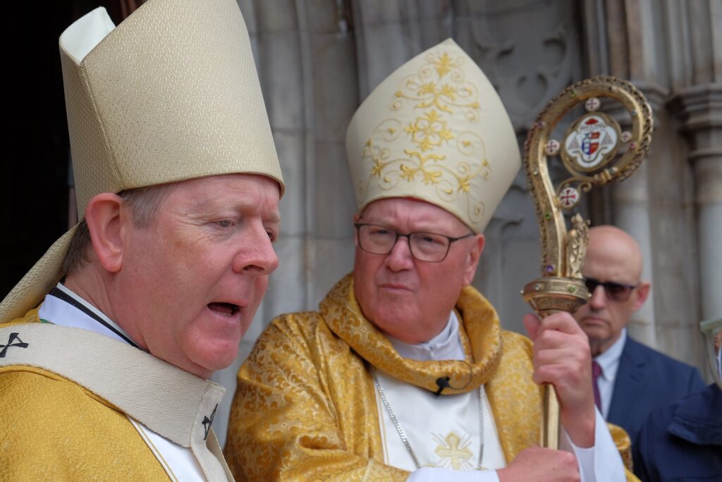 Irish Archbishop Eamon Martin of Armagh and New York Cardinal Timothy M. Dolan chat after concelebrating a Mass to mark the 150th anniversary of Armagh's St Patrick's Cathedral Aug. 27, 2023.