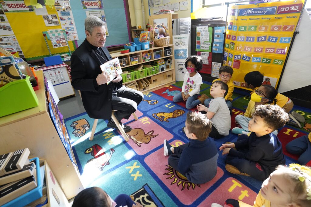 Bishop Robert J. Brennan of Brooklyn, N.Y., reads "The Little Engine That Could" to pre-kindergarteners during his Catholic Schools Week visit to Divine Mercy Catholic Academy in the Ozone Park section of Queens, N.Y., Jan. 30, 2023.