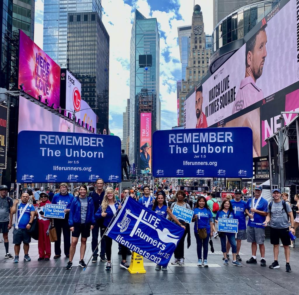 Participants of the A-Cross America Relay for Life stop at Father Duffy Square in Times Square Saturday, August 26, 2023.