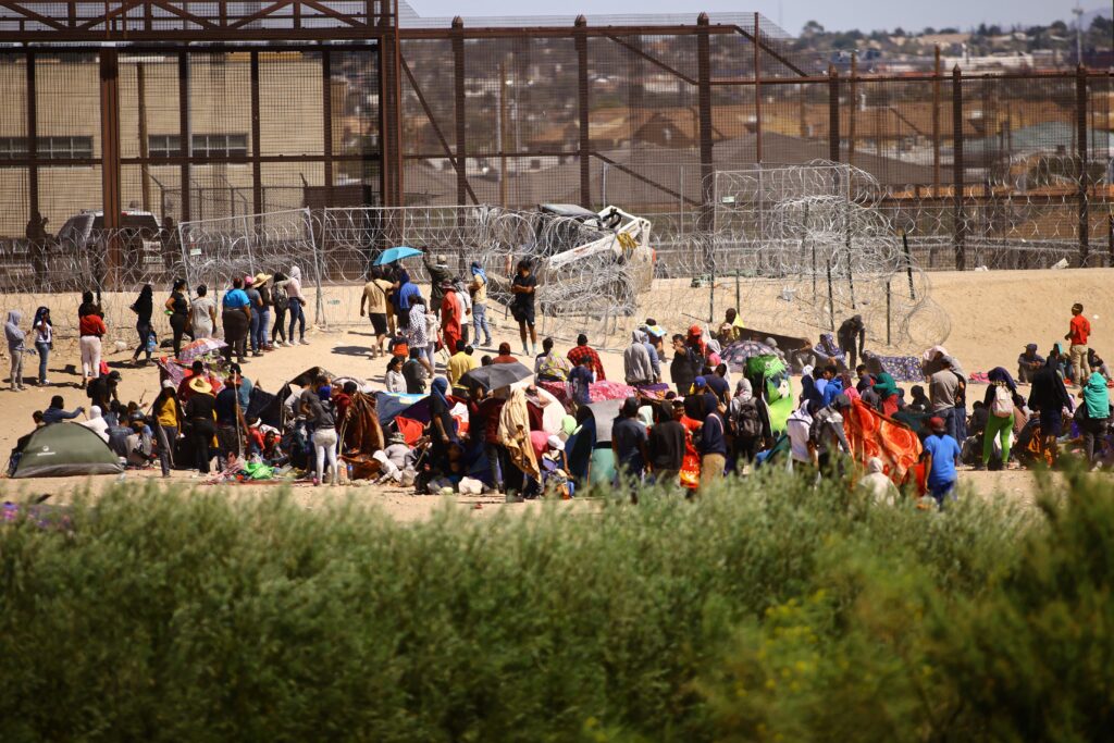 Migrants, mostly from Venezuela, are seen seen from Ciudad Juarez, Mexico, as they gather near the U.S. border wall Sept. 24, 2023,.