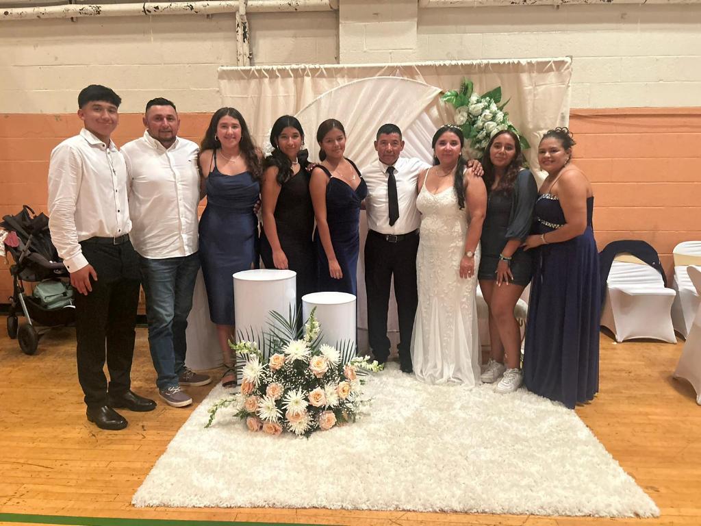 Edilberto (wearing tie) and Vilma Cruz with family members and friends during the reception that followed the Sept. 8 group wedding at St. Patrick-St. Mary parish in Newburgh.
