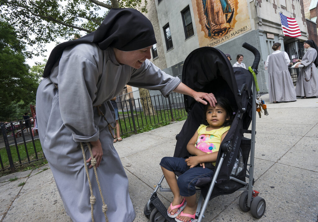 Mother Clare Matthiass greets a child outside The Sisters of Our Lady Queen of Angels convent, July 15, 2015.