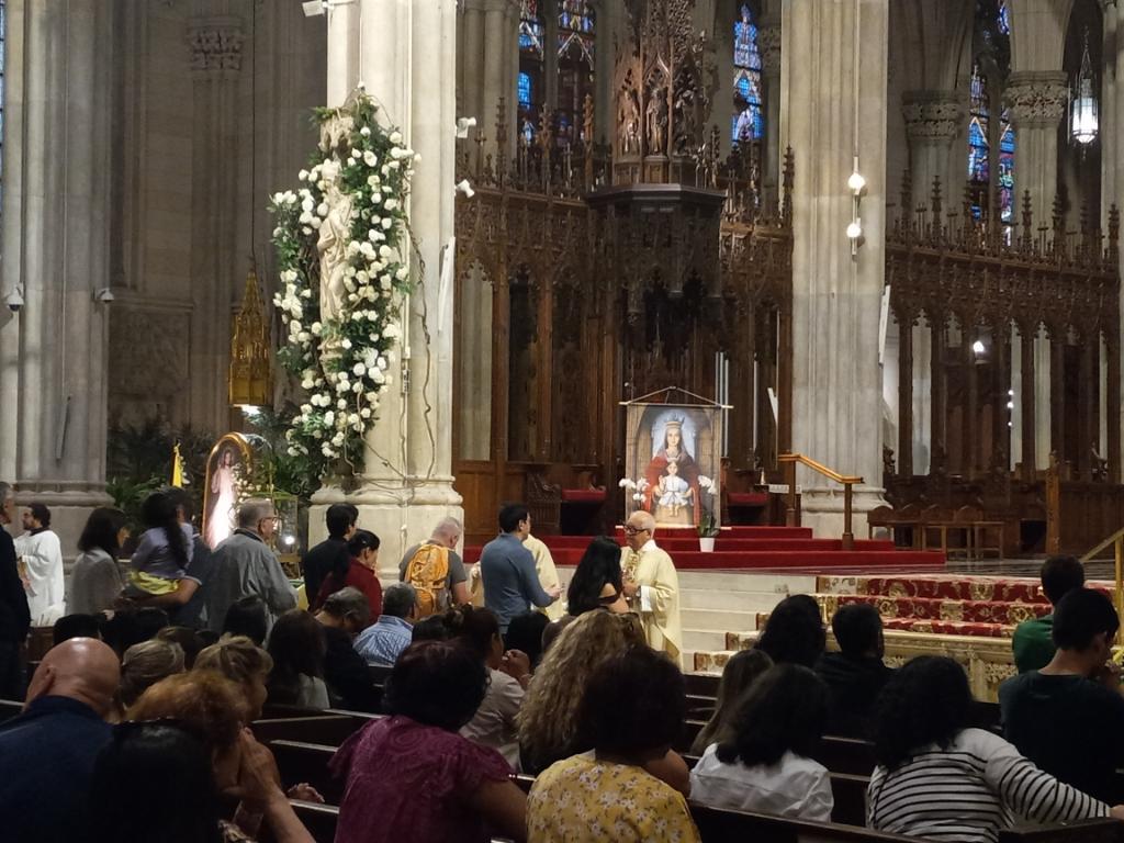 Father Alexis Bastidas (center, white vestments), pastor of St. Teresa Church in Lower Manhattan, during communion on Sunday, September 17 in the annual Mass honoring Our Lady of Coromoto at St. Patrick's Cathedral.