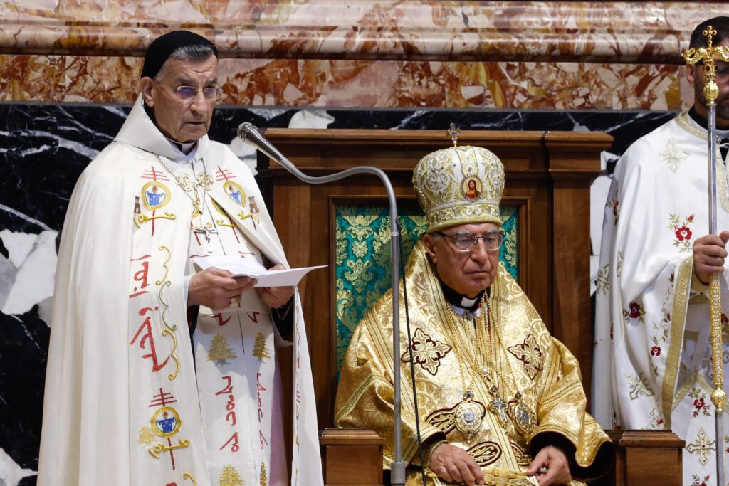 Cardinal Béchara Raï, patriarch of the Maronite Catholic Church, gives his homily as Melkite Catholic Patriarch Joseph Absi sits quietly during the celebration of a Byzantine Divine Liturgy as part of the assembly of the Synod of Bishops at the Altar of the Chair in St. Peter's Basilica at the Vatican on October 9, 2023.