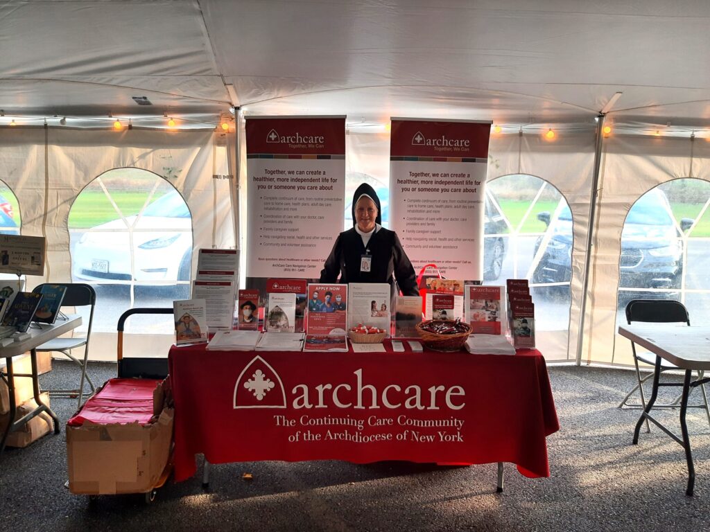 Sister Mary Anne Dennehy welcomes visitors to the ArchCare table at the New York State Eucharistic Congress in Auriesville, October 20-22, 2023.